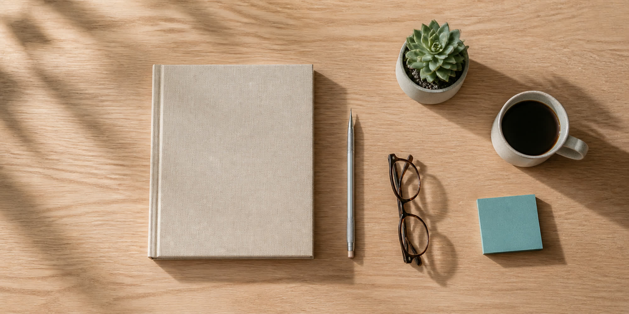Overhead view of a quiet design-studio desk — generated illustration